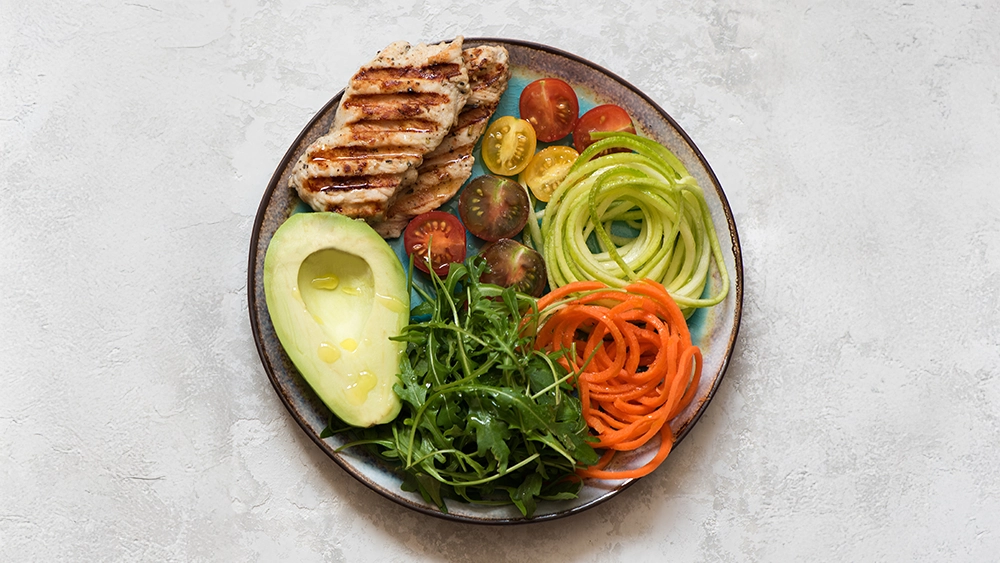 balanced-food-concept-salad-with-grilled-chicken-breast-arugula-avocado-carrots-zucchini-balanced-clean-eating-top-view-healhty-lunch-bowl