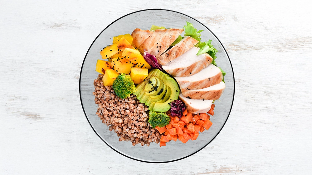 bowl-buddha-buckwheat-pumpkin-chicken-fillet-avocado-carrots-white-wooden-background-top-view-free-space-your-text